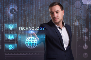 The concept of business, technology, the Internet and the network. A young entrepreneur working on a virtual screen of the future and sees the inscription: Technology