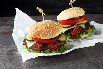 fresh tasty burger on wooden grey background
