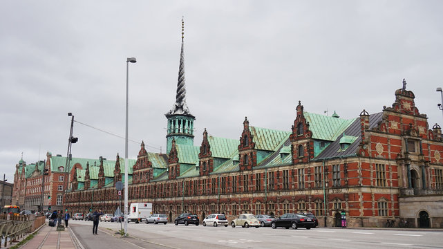 COPENHAGEN, DENMARK - MAY 31, 2017: B&oslash;rsen in B&oslash;rsgade street is 17th-century stock exchange in the center of Copenhagen. Most noted for its spire, shaped as the tails of four dragons twined together