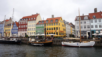 Fototapeta na wymiar COPENHAGEN, DENMARK - MAY 31, 2017: The Nyhavn canal. Nyhavn is waterfront, canal and entertainment district in Copenhagen. It is lined by brightly coloured bars, cafes and restaurants, Denmark