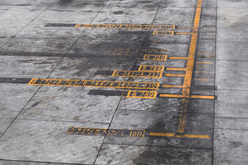 Close-up of Airplane ramp markings sign strips at the airport.