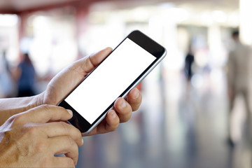  Man using smartphone in railway. Blank screen smartphone for graphic display montage.