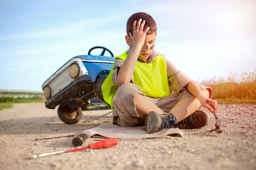 help on the road, a young boy with his toy car © V&P Photo Studio