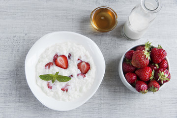 Dairy rice porridge with strawberries in a plate