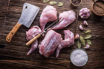 Photo sur Plexiglas Anti-reflet Viande Rabbit. Raw rabbit slices with spices garlic kitchen utensil,fork and butcher. Hunting cuisine.