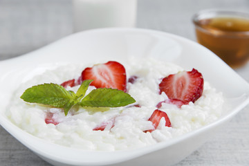 Dairy rice porridge with strawberries in a plate