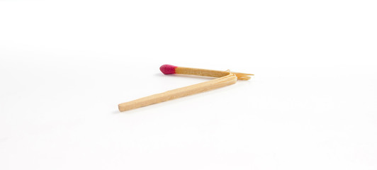 One broken match with rose match head on white background