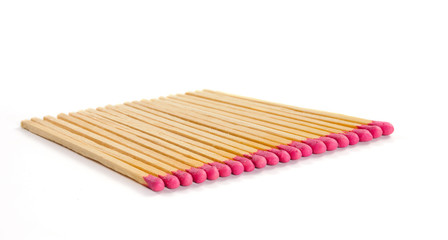 Row of matches with rose match heads on white background