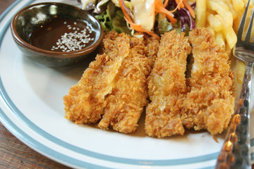 fried chicken and french fries on a wooden background