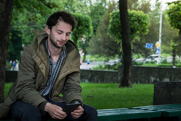 Young man reading e-book