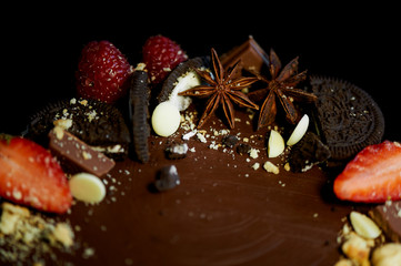 The chocolate cherry cake, decorated with strawberries, biscuits and strawberry shortcake.A masterpiece of culinary art