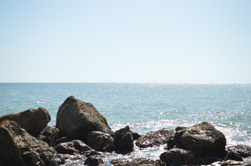 Sunny panoramic view of the ocean with rocks, seascape natural outdoors background