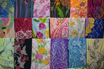 Fototapeta na wymiar Various design of batik painting hanging in craft shop in Kuala Terengganu, Malaysia.