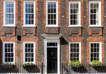 Foto op Canvas Typical street scene in the central London district with familiar architecture facades to urban housing. © daliu