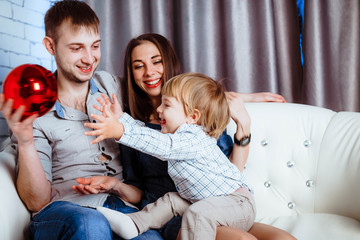 a family with a child sitting on the couch