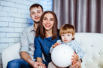a family with a child sitting on the couch