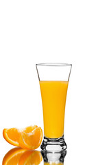 glass of orange juice and orange pieces, mirror reflection, isolated background
