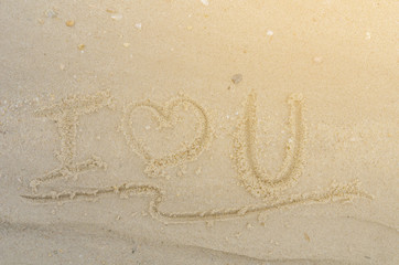Letter I Love U of the alphabet writing on the sand
