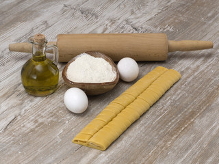 Italian pasta on a wooden table. 