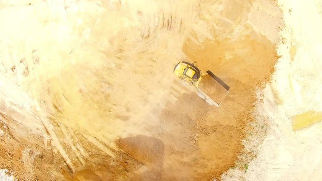 Aerial view of truck on muddy road on a construction site. Heavy industry from above. Industrial background from devastated landscape. 
