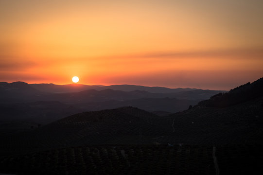 Panoramic and idyllic Andalusian landscape, mountain village Alcaudete at sunset