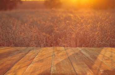 wooden table with field with ripe corn ears of corn