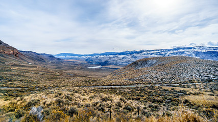 Fototapeta na wymiar Thompson River flowing through semi desert landscape of the Thompson River Valley viewed from Juniper Beach Provincial Park betweeen Kamloops and Cache Creek, British Columbia, on a cold winter day