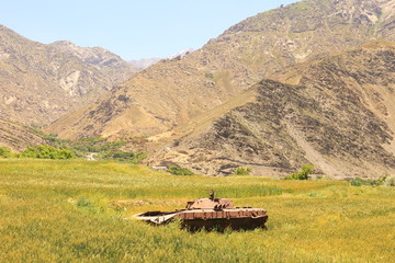 Rusty tank abandoned in the field