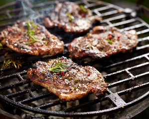 Grilled pork neck fillet steaks on grilled plate