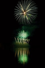 Beautiful colorful fireworks on the water surface with a clean black background. Fun festival and international contest of Firefighters  Ignis Brunensis 2017. Brno Dam - Czech Republic.
