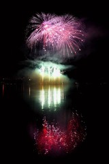Beautiful colorful fireworks on the water surface with a clean black background. Fun festival and international contest of Firefighters  Ignis Brunensis 2017. Brno Dam - Czech Republic.