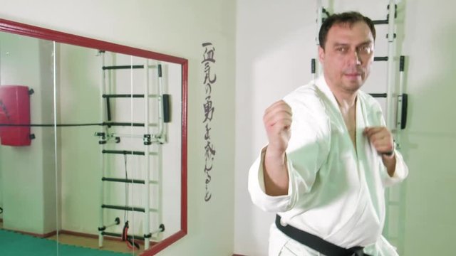 A man is practicing and doing karate exercises 4k