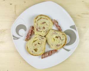 savory cake with salami, ham and cheese on wooden background - top view