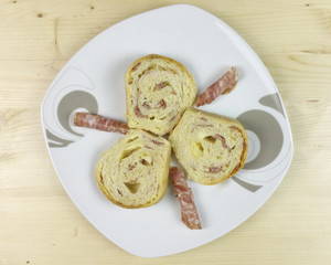 savory cake with salami, ham and cheese on wooden background - top view