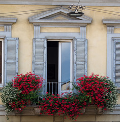 Balcony decorated with white and red flowers
