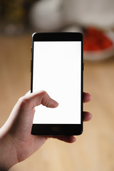 female teen hand using smartphone with blank white screen, shallow focus