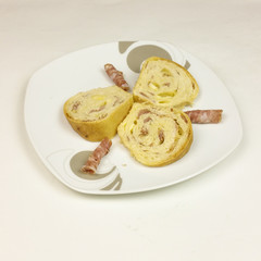 savory cake with salami, ham and cheese on white background - top view