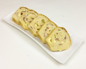 savory cake with salami, ham and cheese on white background - top view