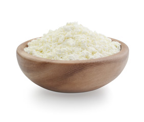 Cottage cheese in a wooden bowl isolated on white