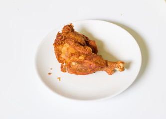 crispy  fried chicken in  the white dish on a wooden table , close up delicious fried chicken , close up