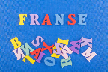 FRENCH word on blue background composed from colorful abc alphabet block wooden letters, copy space for ad text. Learning english concept.