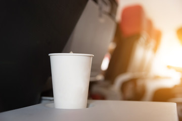 Drink in a glass of white paper on the plane.