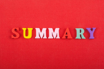 SUMMARY word on red background composed from colorful abc alphabet block wooden letters, copy space...