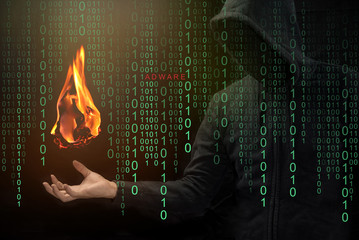 Hacker show a fireball on his hand with green digital binary in foreground. Fireball Adware Infects...