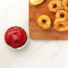 Calamari rings, red sauce, lemon, copyspace
