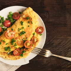 Omelette with parsley, cherry tomatoes, and copyspace