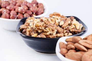 Assorted nuts in ceramic bowls