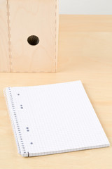 Brown wooden office desk with empty notepad and folders