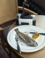 Fish and lemon as a dinner background. Concept and idea of a tasty food