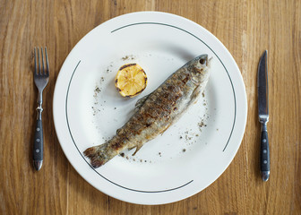 Fish and lemon as a dinner background. Concept and idea of a tasty food